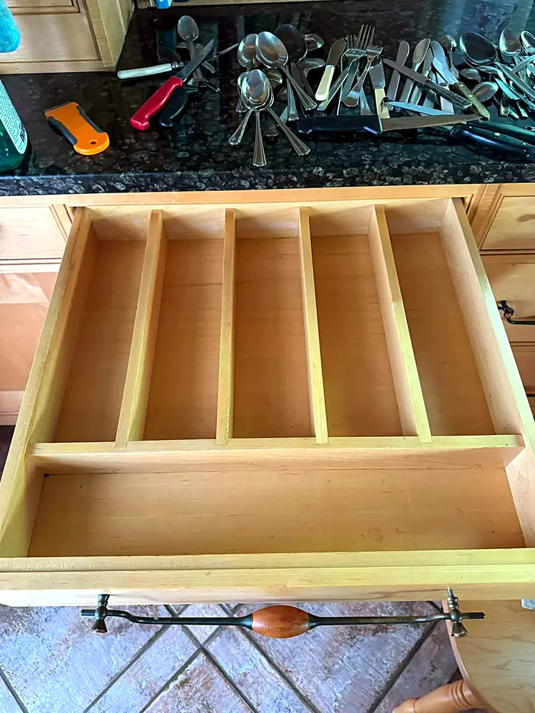 The same cutlery drawer emptied and wiped clean
